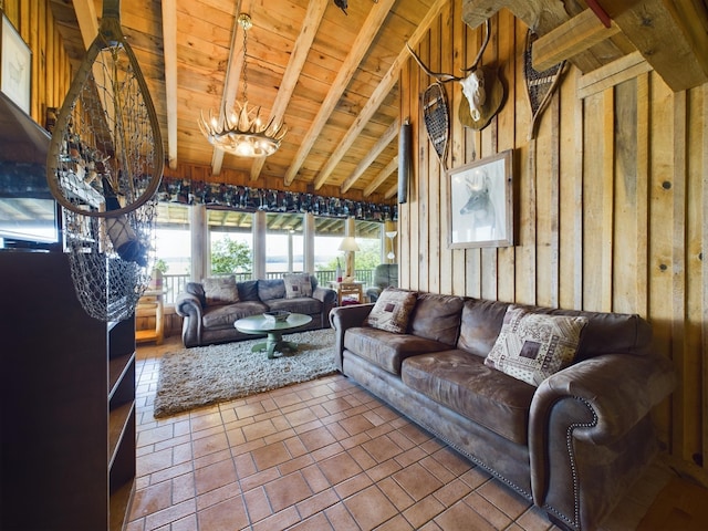 living room with lofted ceiling with beams, a notable chandelier, wooden walls, and wood ceiling