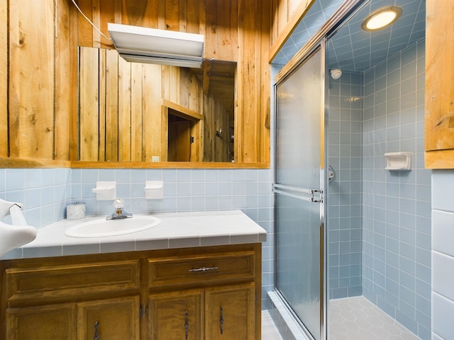 bathroom with vanity and a shower with door