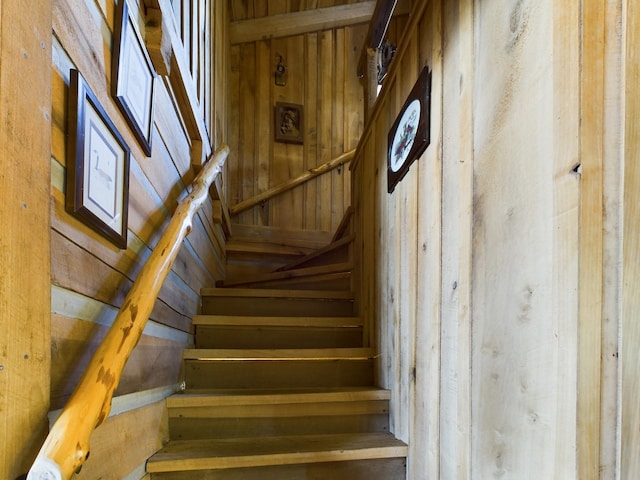 stairway with wood walls