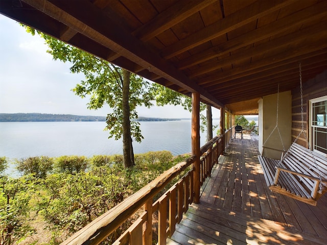 wooden terrace featuring a water view