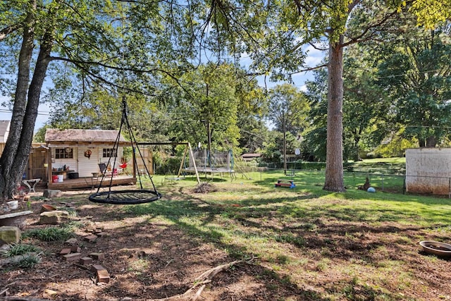 view of yard with a playground and a trampoline