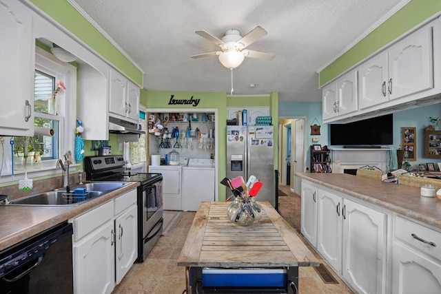 kitchen featuring washing machine and clothes dryer, sink, a textured ceiling, appliances with stainless steel finishes, and white cabinets