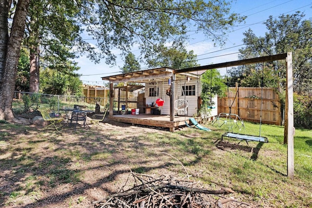 view of yard featuring an outdoor structure and a deck