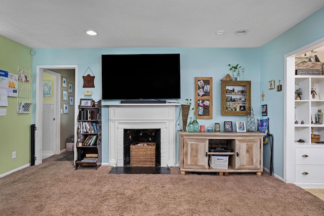 carpeted living room featuring a fireplace and a textured ceiling