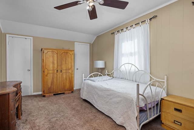 bedroom with lofted ceiling, dark carpet, and ceiling fan