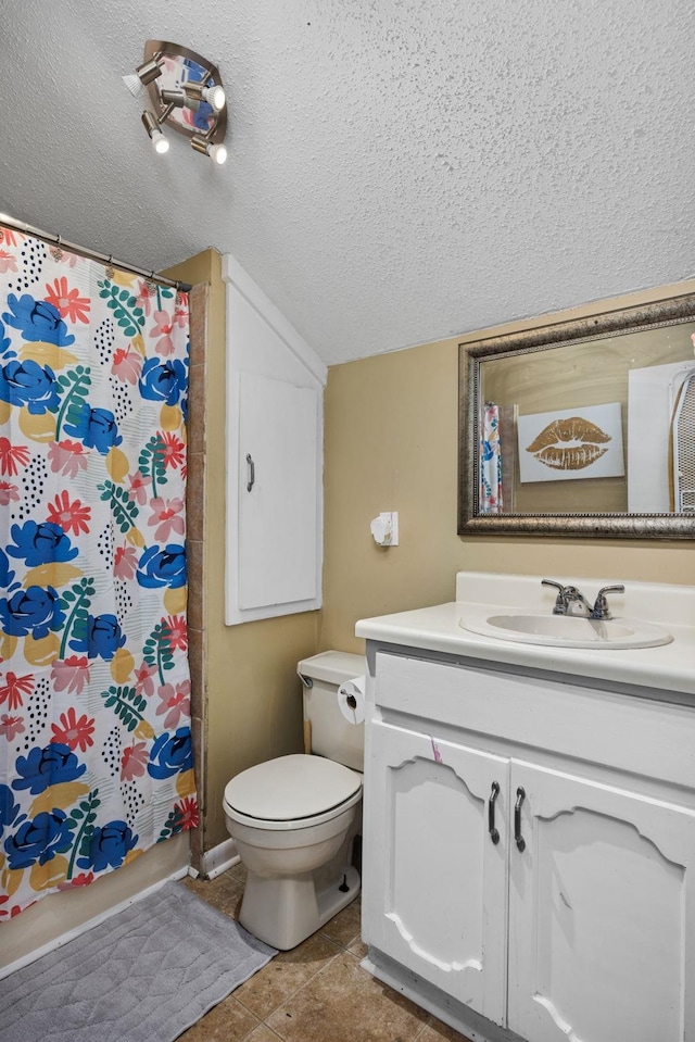 bathroom featuring vanity, walk in shower, a textured ceiling, and toilet