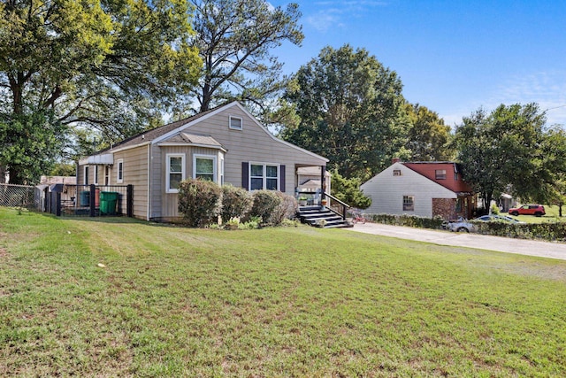 bungalow-style house featuring fence and a front yard