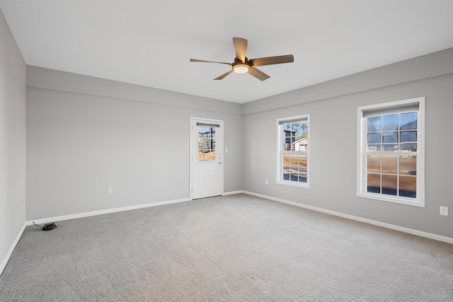 empty room featuring carpet floors and ceiling fan