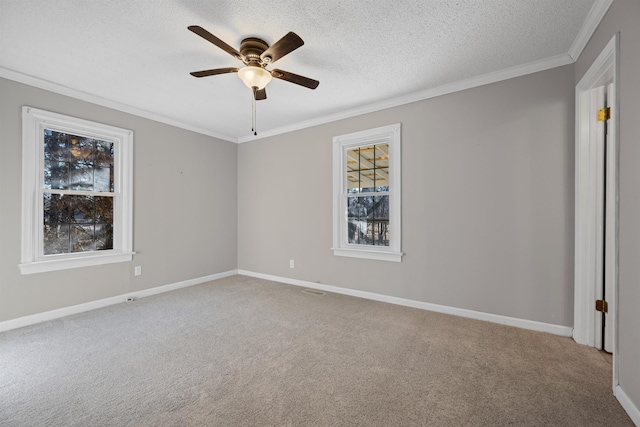 unfurnished room featuring ceiling fan, carpet floors, ornamental molding, and a textured ceiling