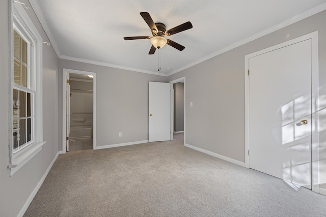 unfurnished bedroom with light carpet, ornamental molding, ceiling fan, and ensuite bathroom