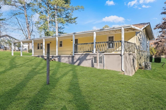 exterior space with central AC and a lawn