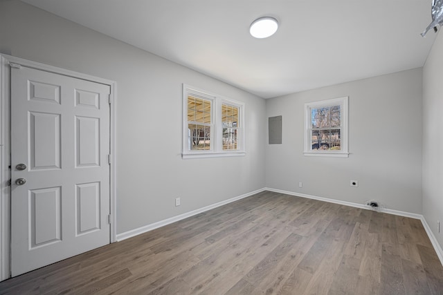 interior space with light hardwood / wood-style flooring and electric panel