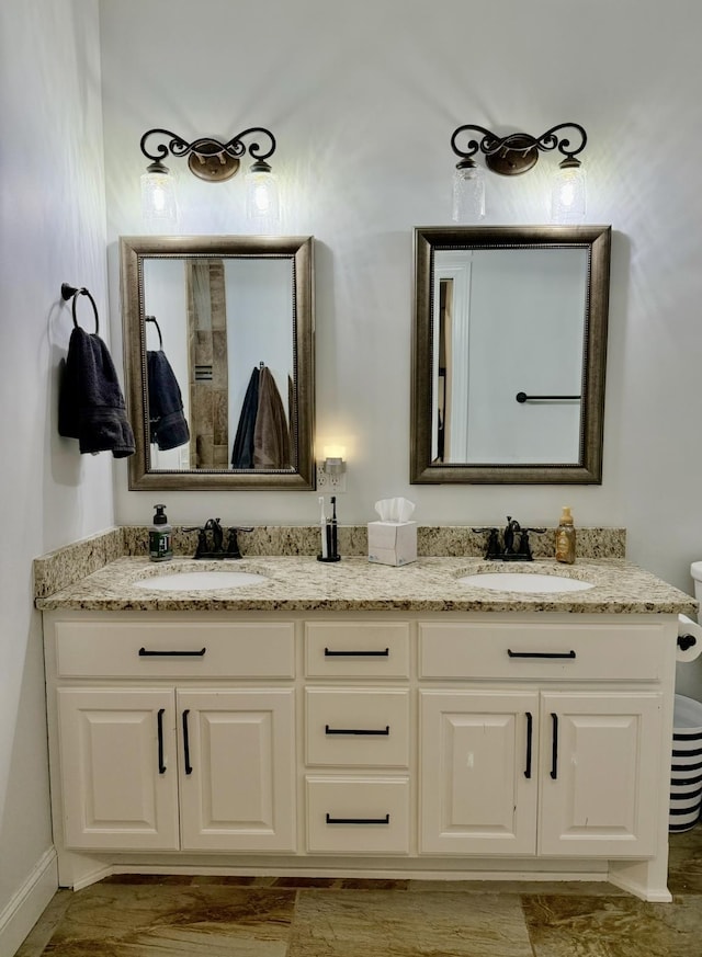 bathroom featuring a sink and double vanity