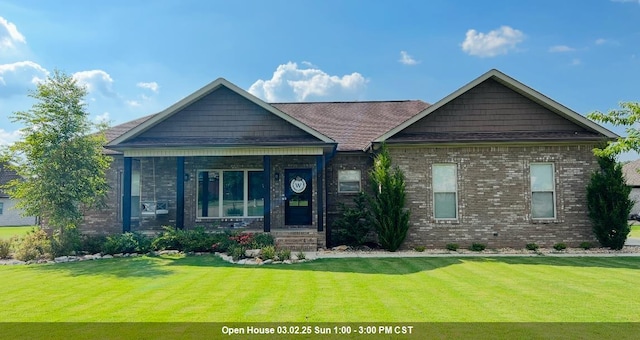 view of front of home featuring brick siding and a front lawn