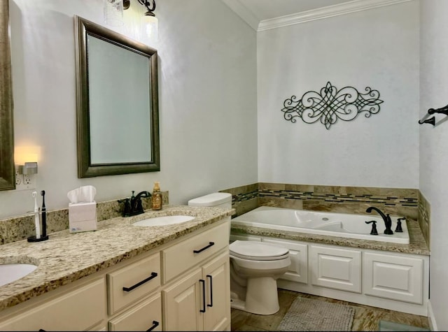 bathroom featuring a garden tub, double vanity, toilet, ornamental molding, and a sink