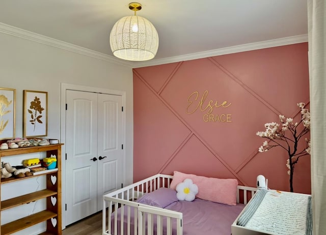 bedroom featuring a closet, crown molding, and wood finished floors