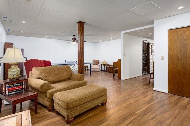  - living area featuring wood finished floors, ceiling fan, and a paneled ceiling