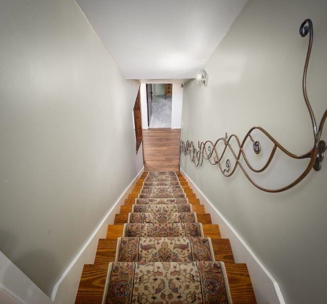  - staircase featuring baseboards
