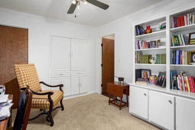  - living area featuring a ceiling fan, light colored carpet, and crown molding