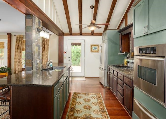  - kitchen featuring stainless steel appliances, ceiling fan, a warming drawer, beamed ceiling, and dark wood finished floors