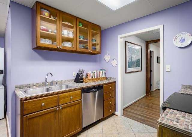  - kitchen with dishwasher, stove, light countertops, and brown cabinets