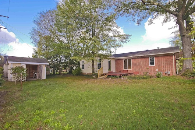 rear view of property featuring a deck and a lawn