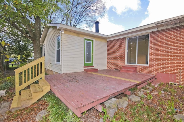 rear view of property with a wooden deck