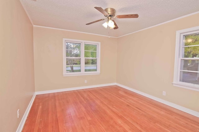 unfurnished room with crown molding, ceiling fan, light hardwood / wood-style floors, and a textured ceiling