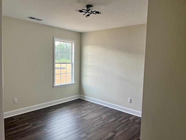 spare room with dark wood-type flooring