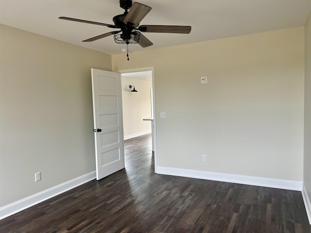 spare room featuring ceiling fan and dark wood-type flooring