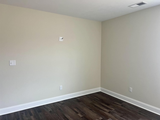 spare room with dark wood-type flooring