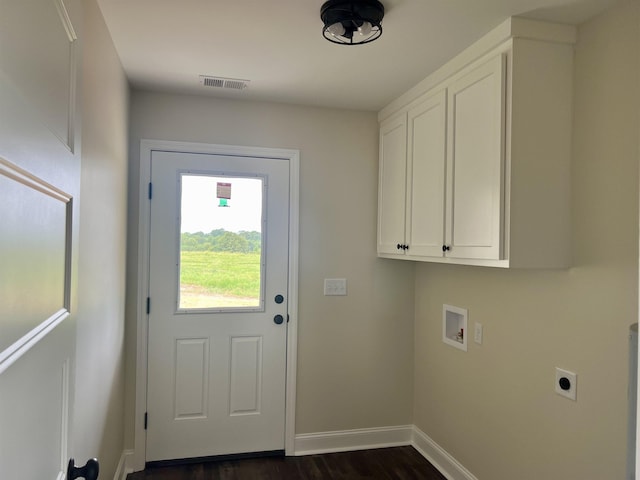 laundry room featuring electric dryer hookup, dark wood-type flooring, cabinets, and washer hookup