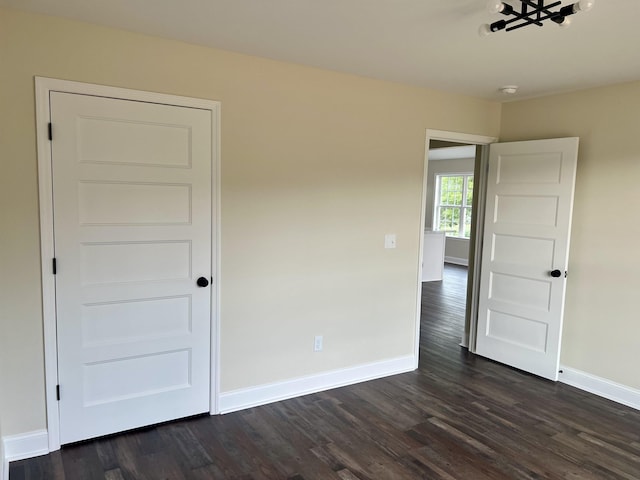 unfurnished room featuring dark hardwood / wood-style floors