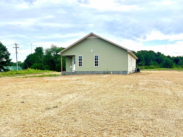 view of side of home with central air condition unit