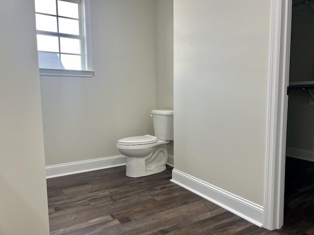 bathroom with hardwood / wood-style floors and toilet