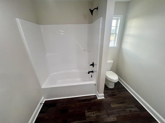 bathroom featuring wood-type flooring, shower / bath combination, and toilet