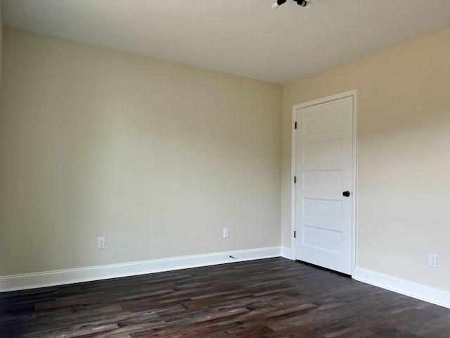 empty room with dark hardwood / wood-style floors