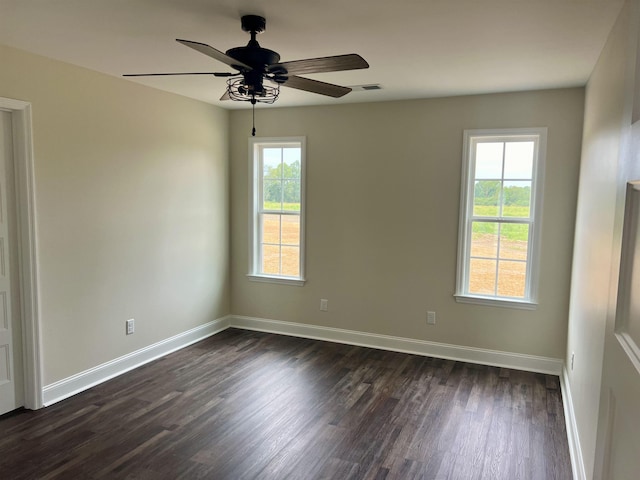 spare room featuring ceiling fan and dark hardwood / wood-style flooring