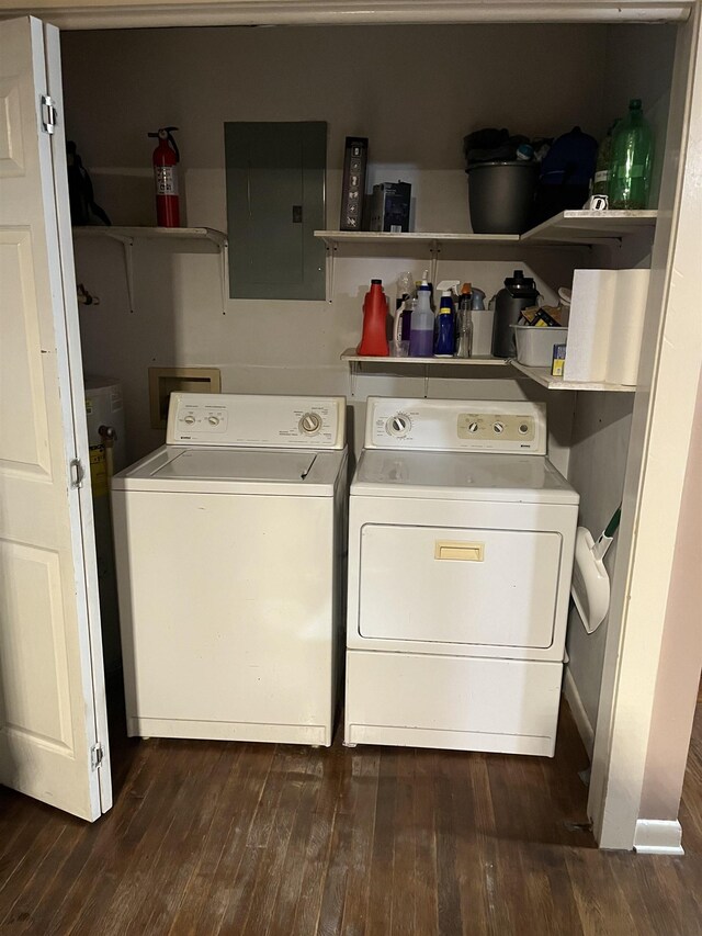 laundry room with washing machine and dryer, electric panel, and dark hardwood / wood-style floors