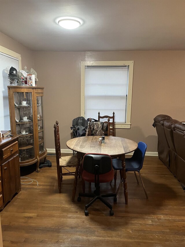 dining area with dark hardwood / wood-style flooring