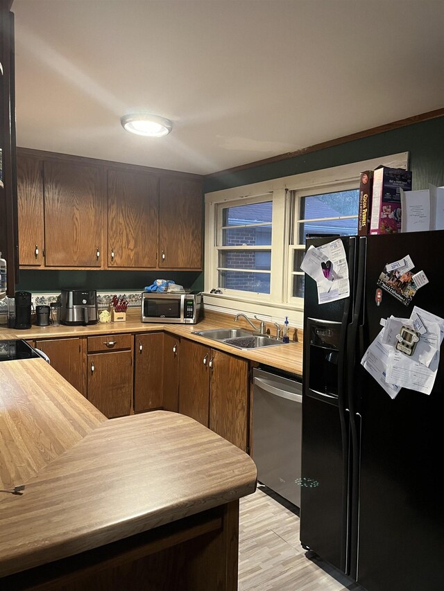 kitchen featuring light hardwood / wood-style floors, sink, and stainless steel appliances