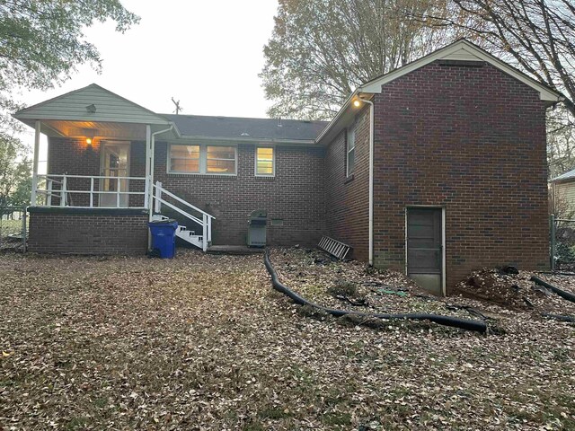 back of property with covered porch