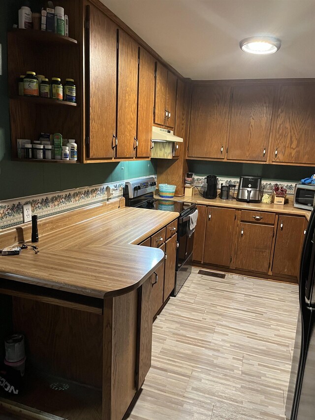 kitchen with kitchen peninsula, stainless steel appliances, and light hardwood / wood-style floors