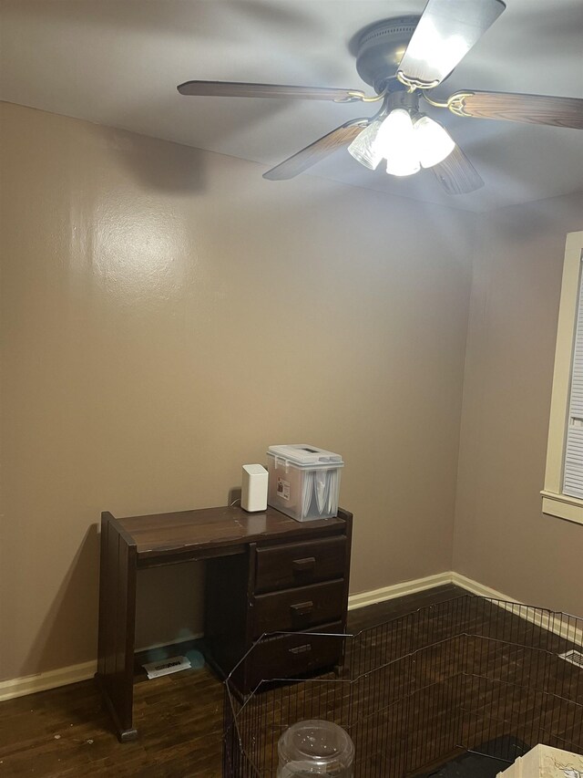 unfurnished office featuring ceiling fan and dark hardwood / wood-style flooring