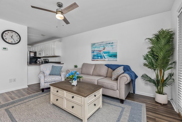 living room with dark hardwood / wood-style floors and ceiling fan