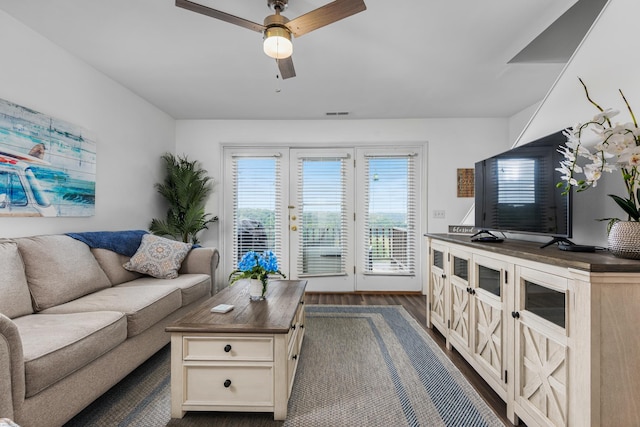 living room featuring dark hardwood / wood-style floors and ceiling fan