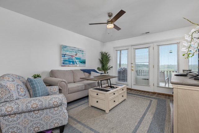 living room with ceiling fan and wood-type flooring