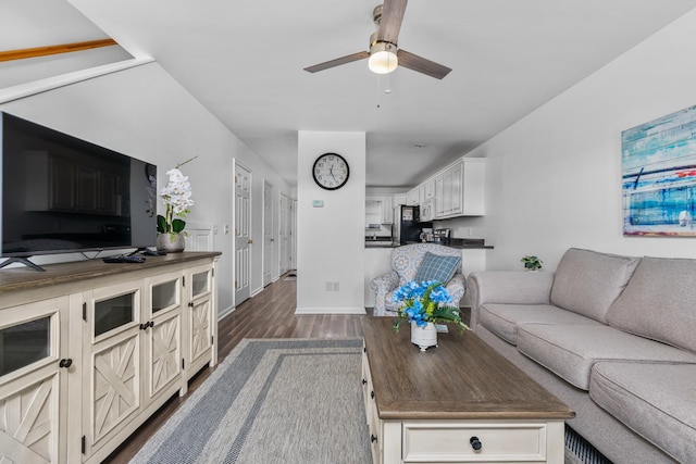 living room with ceiling fan and dark hardwood / wood-style floors