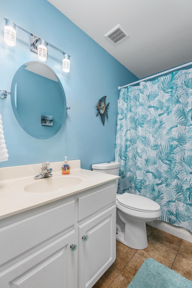 bathroom featuring tile patterned flooring, vanity, and toilet