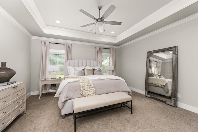  - bedroom with multiple windows, a tray ceiling, light colored carpet, crown molding, and baseboards
